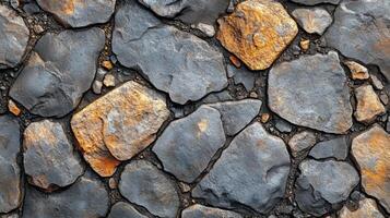 Textured stone surface with varying colors and shapes captured in natural light photo