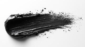 Black paint applied smoothly on a surface showcasing rich texture and depth during an artistic creation process photo