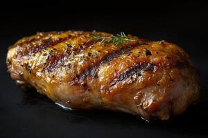 Baked grilled chicken on dark background. Delicious food in restaurant with copy space photo