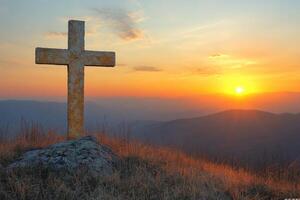 cross on the mountain at sunset photo