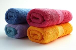three towels in different colors are stacked on top of each other photo