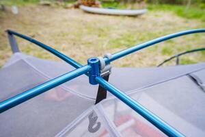 A highly detailed closeup view of an aluminum tent pole junction situated in a serene and beautiful natural setting, capturing the essence of adventure and outdoor exploration in a profound way photo