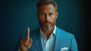 a man in a suit pointing his finger up photo