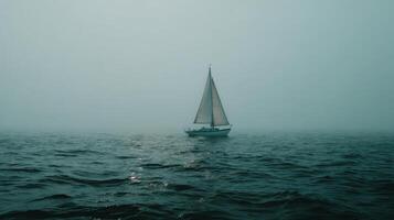 Foggy Sailing Adventure with a White Sailboat Gliding Across Calm Waters in Mysterious Atmosphere and Soft Light photo