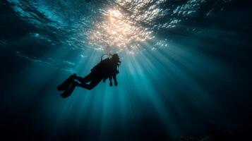 Diver Underwater Surrounded by Sunlight Rays Piercing Through Ocean Water in a Serene Marine Environment photo