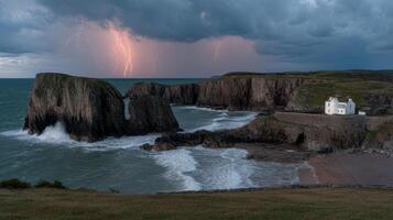 Dramatic Seascape with Lightning Striking Over Rocky Cliffs and a White House by the Shore at Dusk photo