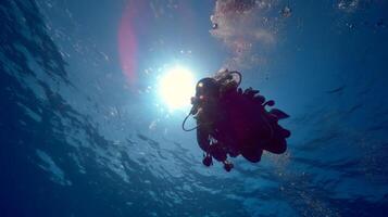 Underwater Exploration with Diver Silhouette Against Sunlight in Clear Blue Ocean Water photo