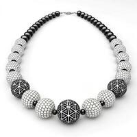 Stylish black and white beaded necklace with intricate patterns on a white background with copy space photo