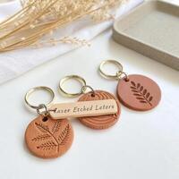 Stylish leather keychains with engraved designs on a light background for personalized accessory concept photo