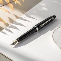 Elegant fountain pen on a clean notebook with shadows and a touch of nature for writing and creativity photo