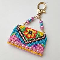 Colorful beaded handbag keychain on a white background with copy space photo