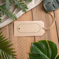 Natural kraft paper tag with green outline on a wooden surface surrounded by tropical leaves for eco-friendly branding concept photo