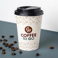 Coffee cup with modern branding and design on a green background with coffee beans photo