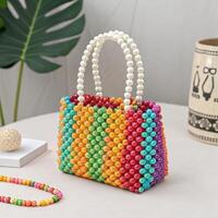 Colorful beaded handbag on a table with decorative elements and tropical background photo