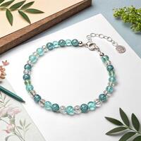Elegant beaded bracelet with shimmering gemstones on a soft pastel background with copy space photo
