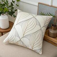 Decorative leaf-patterned cushion on sofa in cozy living space with stylish greenery and aesthetic decor with copy space photo