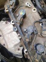 Ignition System of a Fiat 500 Sport 1.4 with Coils and Connectors - Engine Components Close-up of the Ignition Coils Attached to the Cylinder Head of a Fiat 1.4 16V Engine photo