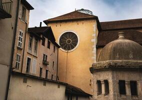 a church with a rose window and a building in the background photo