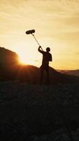 Silhouette Of Film Sound Recordist Is Capturing Background Nature On Mountains video