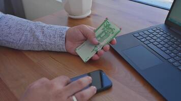A man is using his phone to pay for a coffee video