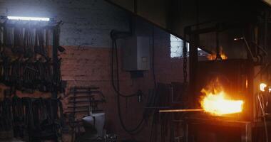 A man is working in a metal shop with a torch photo