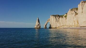 The beach is filled with white cliffs and water photo
