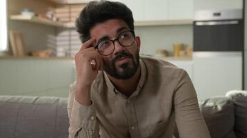 Thoughtful Indian man confused puzzled Arabian muslim guy thinking idea in home kitchen pensive think deep in thoughts pondering dreaming solving difficult solution creative imagine search inspiration video