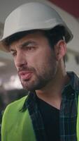 Furious irritated Caucasian workman architect foreman talking walkie talkie guy handyman inspector shouting man argument in construction male control manufacture builder screaming dissatisfaction work video