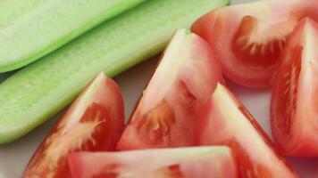 Tomatoes and cucumbers are sliced into pieces video