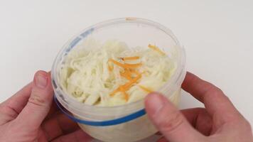 A person holding a container with shredded cabbage video