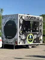 Warsaw, Poland - May 04, 2025 Food truck serving Bingsu dessert with colorful graphics and menu displayed in a vibrant outdoor setting photo