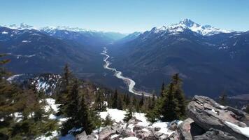 Aerial View of River Flowing Through Valley with Snowy Mountains video