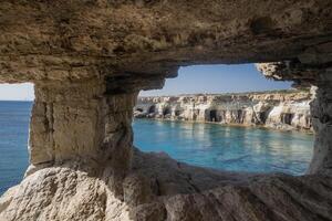 Breathtaking coastal landscape of Cape Ayia Napa, also known as Cape Greco, located on the southeastern coast of Cyprus. Featuring dramatic limestone cliffs, crystal-clear turquoise waters photo