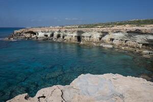 Breathtaking coastal landscape of Cape Ayia Napa, also known as Cape Greco, located on the southeastern coast of Cyprus. Featuring dramatic limestone cliffs, crystal-clear turquoise waters, photo