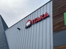 Warsaw, Poland - May 22, 2025 ITAKA brand logo prominently displayed on modern building facade, showcasing contemporary architecture and design elements in urban environment photo