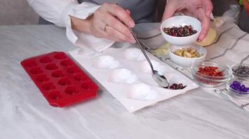 Preparation of home chocolate sweets with berries and nuts with silicone molds video