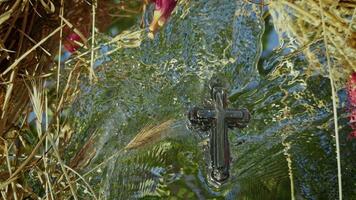 The Christian Symbol Cross On Holy Water and Reflection of Tree Leaves and Sky video