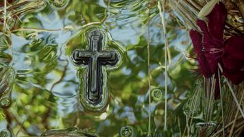 Christian Religion Symbol of Cross On Holy Water and Reflection of Tree Leaves and Sky video