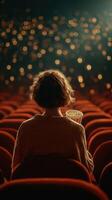 Enjoying a movie in a cozy theater with popcorn in hand as lights dim for the show photo
