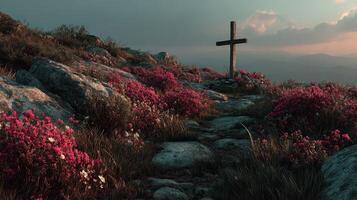 Scenic hillside with cross and vibrant flowers at sunset in a tranquil mountain setting photo