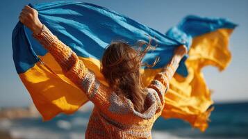 Celebrating freedom and unity by waving the Ukrainian flag on a sunny beach day photo