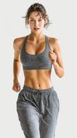 Female runner jogging in sports attire during early morning workout session in a serene environment photo