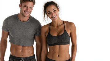 Happy fitness couple posing together after workout in a bright studio setting photo
