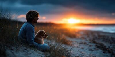 Enjoying a tranquil evening by the beach with a loyal dog while the sun sets over the horizon photo