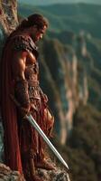 Warrior stands on cliff edge overlooking vast landscape at dusk in a moment of reflection photo