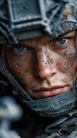 Intense expression of a soldier covered in dirt and grime from combat training in a forest environment photo
