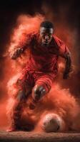 Dynamic soccer player in red uniform kicking a ball in a cloud of dust photo