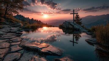 Sunset over tranquil lake with a cross reflection in the mountains photo