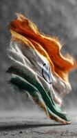 Indian flag beautifully waving in the air against a blurred gray background showcasing vibrant colors photo