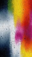 Colorful abstract texture created with spray paint on a rough surface in an urban setting during daytime photo